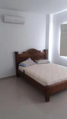a bedroom with a wooden bed in a room at Cabaña Villa Flower Gold in Juan de Acosta