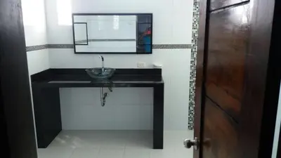 a bathroom with a sink and a mirror at Cabaña Villa Flower Gold in Juan de Acosta