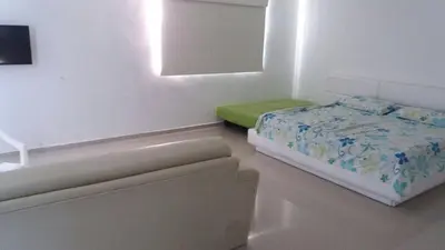 a white room with a bed and a window at Cabaña Villa Flower Gold in Juan de Acosta