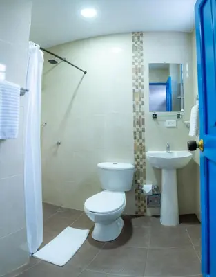 a bathroom with a toilet and a sink at Casa Caribe Colonial in Barranquilla