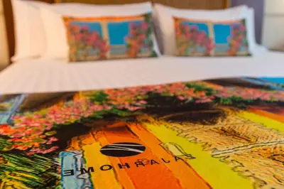 a close up of a bed with flowers on it at Hotel Dann Cartagena in Cartagena de Indias
