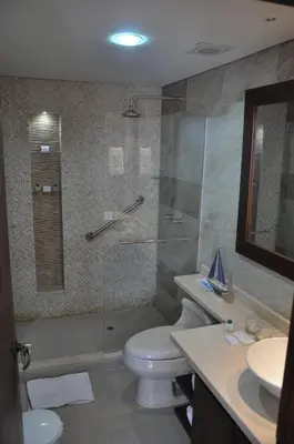 a bathroom with a shower and a toilet and a sink at Hotel Isla Verde in Tubará
