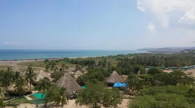 an aerial view of a resort with palm trees and the ocean at Hotel Isla Verde in Tubará