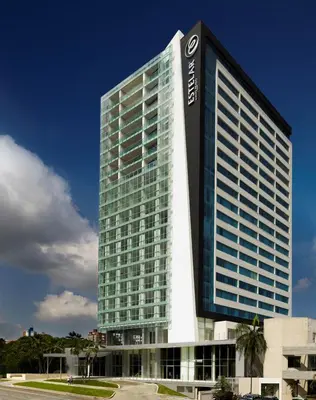 a tall building with a sign on the side of it at Estelar Alto Prado in Barranquilla