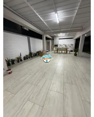 a large room with a wooden floor with potted plants at Sun Beach in Puerto Colombia