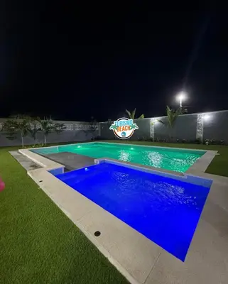 a large blue swimming pool at night at Sun Beach in Puerto Colombia