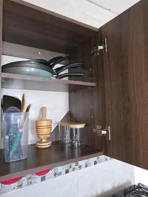 a kitchen with wooden shelves with bowls and utensils at Deusades Apartamentos in Cartagena de Indias