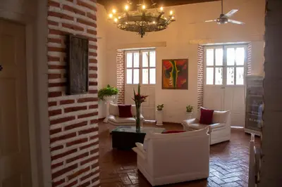a living room with white furniture and a chandelier at Casa Villa Colonial By Akel Hotels in Cartagena de Indias