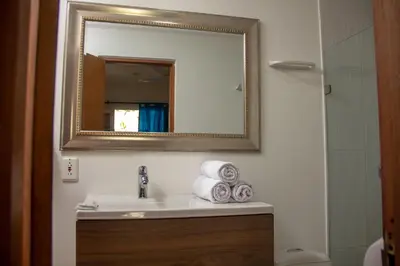a bathroom with a sink with a mirror and towels at Casa Villa Colonial By Akel Hotels in Cartagena de Indias