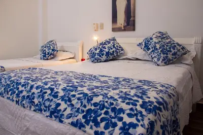two beds with blue and white sheets and pillows at Casa Villa Colonial By Akel Hotels in Cartagena de Indias