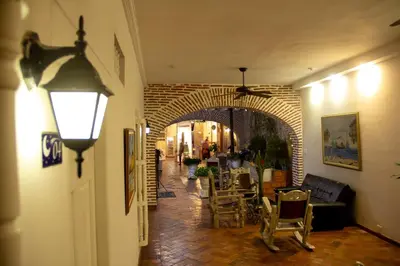 a hallway with an archway with a table and chairs at Casa Villa Colonial By Akel Hotels in Cartagena de Indias