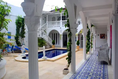 a house with a swimming pool in a yard at Hotel Casa Mara By Akel Hotels in Cartagena de Indias