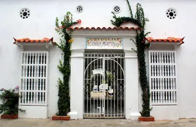 a white building with a gate in front of it at Hotel Casa Mara By Akel Hotels in Cartagena de Indias