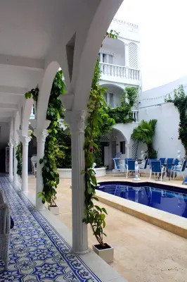 a courtyard with a swimming pool and a building at Hotel Casa Mara By Akel Hotels in Cartagena de Indias