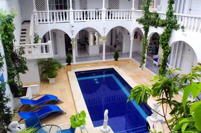 an indoor swimming pool in a house with a courtyard at Hotel Casa Mara By Akel Hotels in Cartagena de Indias
