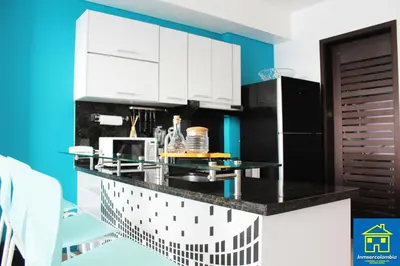 a kitchen with a black and white counter top at Apartamentos Cartagena Oceano - Eliptic in Cartagena de Indias