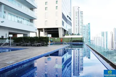 a swimming pool in a city with tall buildings at Apartamento Encantador - H2 Condominio in Cartagena de Indias