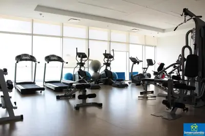 a gym with treadmills and elliptical machines at Apartamento Encantador - H2 Condominio in Cartagena de Indias