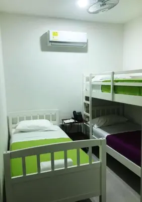 a room with two bunk beds in a room at Hostal Lumar in Barranquilla