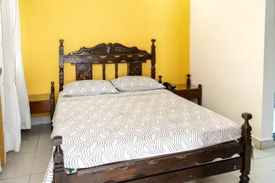 a bed with a wooden frame in a room at Hotel Veleros Cartagena in Cartagena de Indias