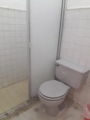 a bathroom with a white toilet and a shower at Hotel Montecarlo Beach in Tolú