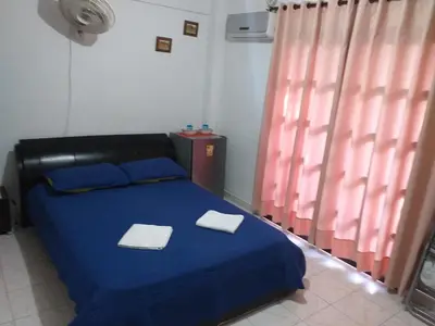 a bedroom with a blue bed with two towels on it at Comfort La Española in Cartagena de Indias