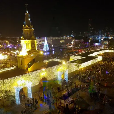 a city at night with a clock tower and christmas lights at Comfort La Española in Cartagena de Indias