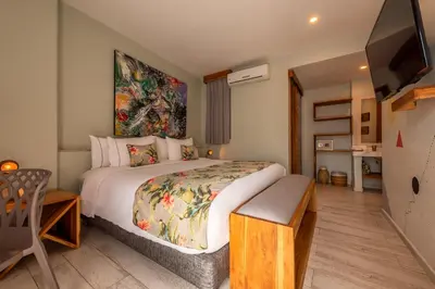 a bedroom with a large bed and a tv at Townhouse Boutique Hotel in Cartagena de Indias