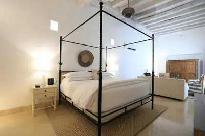 a bedroom with a black canopy bed in a room at Casa Pestagua Relais Châteaux in Cartagena de Indias