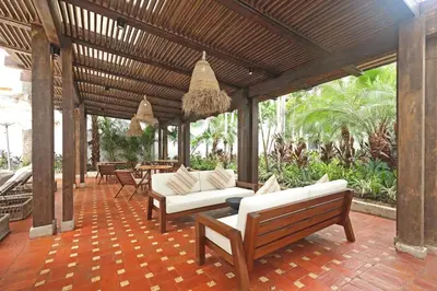 a patio with white couches and chairs and tables at Casa Pestagua Relais Châteaux in Cartagena de Indias