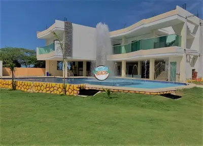 a large house with a fountain in front of it at Special Life Beach in Tubará