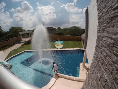 a man standing in front of a fountain in a pool at Special Life Beach in Tubará