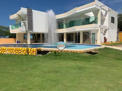 a large house with a fountain in front of it at Special Life Beach in Tubará