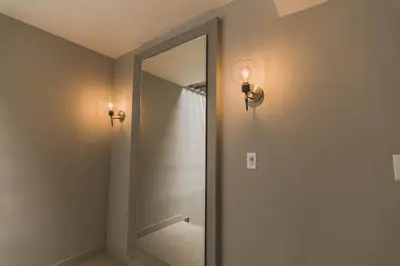 a bathroom with a mirror and lights on the wall at Hotel Santa Cecilia B&B in Cartagena de Indias