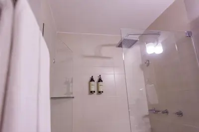 a bathroom with a shower with two bottles at Hotel Santa Cecilia B&B in Cartagena de Indias