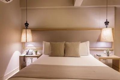 a bedroom with a large bed with two night stands at Hotel Santa Cecilia B&B in Cartagena de Indias