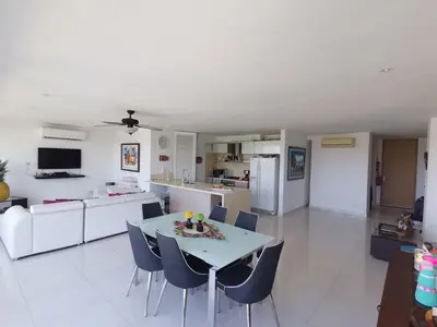 a kitchen and living room with a table and chairs at Karibana Espectacular in Cartagena de Indias