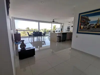 a living room with a view of a kitchen and a dining room at Karibana Espectacular in Cartagena de Indias