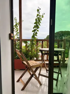 a chair and a table on a balcony at La Terraza de Estella in Cartagena de Indias