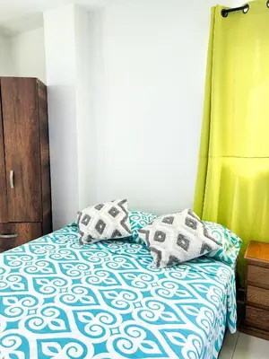 a bedroom with a bed with two pillows on it at La Terraza de Estella in Cartagena de Indias