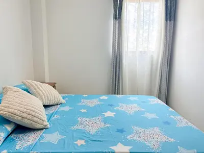 a bed with a blue comforter with stars on it at La Terraza de Estella in Cartagena de Indias