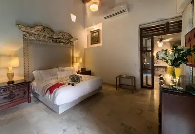 a bedroom with a large white bed in a room at Hotel Boutique Casa Del Arzobispado in Cartagena de Indias