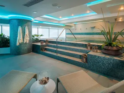 a hotel lobby with stairs and a table and chairs at Las Americas Torre Del Mar in Cartagena de Indias