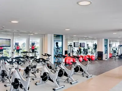 a gym with several treadmills and cardio machines at Las Americas Torre Del Mar in Cartagena de Indias