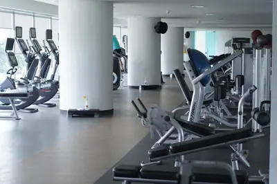 a gym with rows of treadmills and exercise bikes at Las Americas Torre Del Mar in Cartagena de Indias