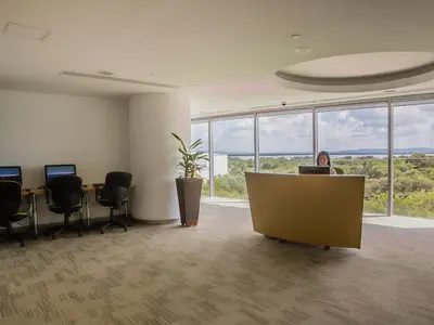 a person sitting at a desk in an office at Las Americas Torre Del Mar in Cartagena de Indias