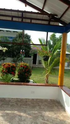a view of a garden from a patio with flowers at Casa de Campo Palmarito in Tubará