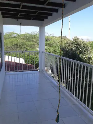 a balcony with a view of the ocean at Casa de Campo Palmarito in Tubará