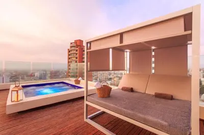 a balcony with a swimming pool on a building at NH Collection Royal Smartsuites in Barranquilla