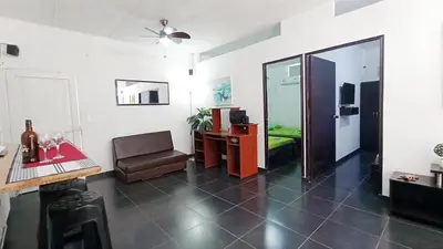 a living room with a table and a chair and a room at Apartamento Aeromar, Santa Marta in Santa Marta